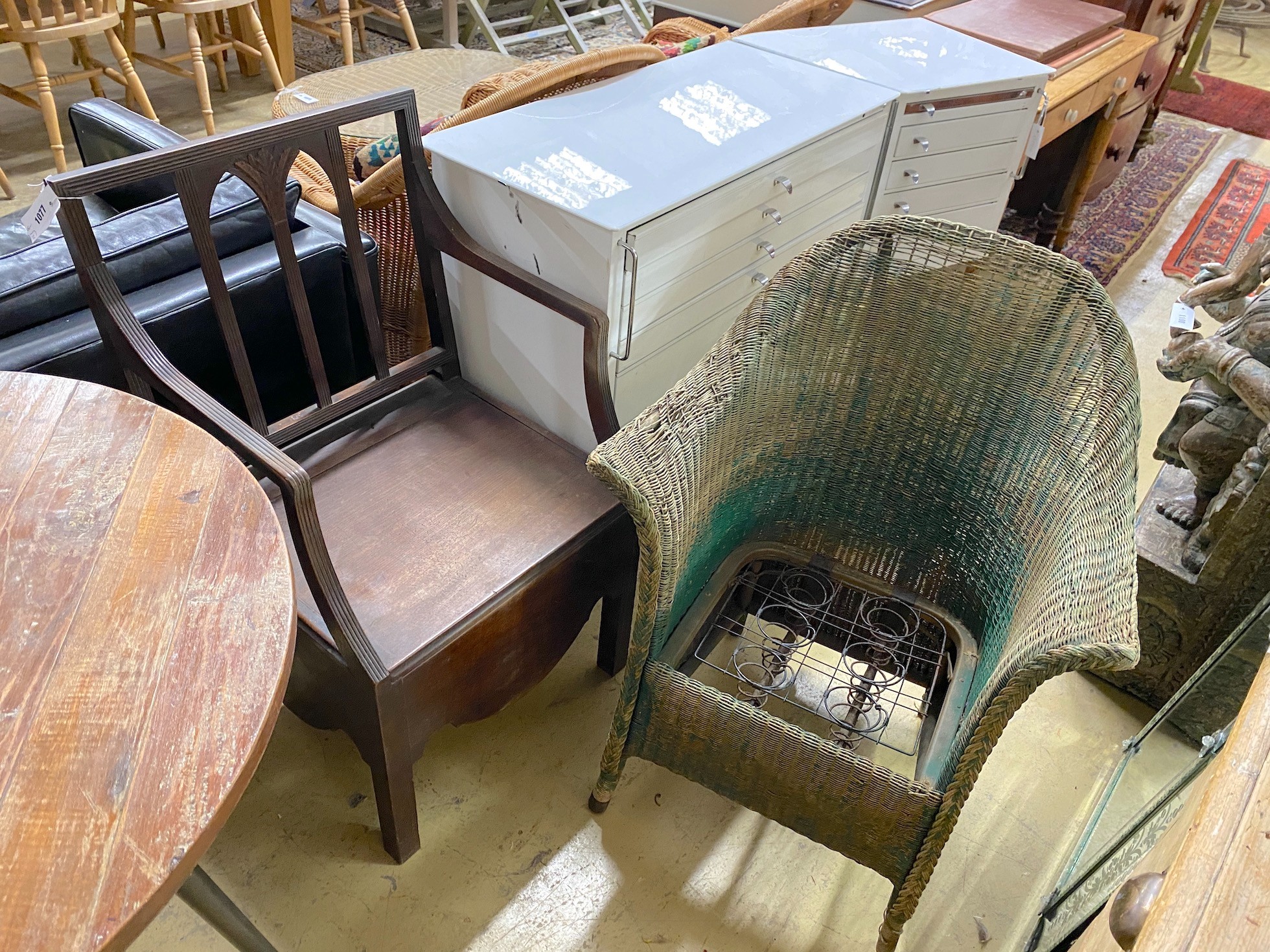 A green painted Lloyd Loom armchair and a Regency mahogany commode chair